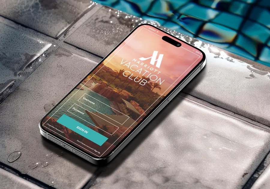 http://Smartphone%20on%20wet%20poolside%20tile%20showing%20the%20Marriott%20Vacation%20Club%20app%20sign-in%20screen.